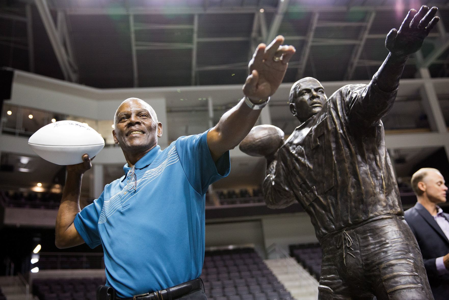 Marlin Briscoe poses with a statue in his likeness